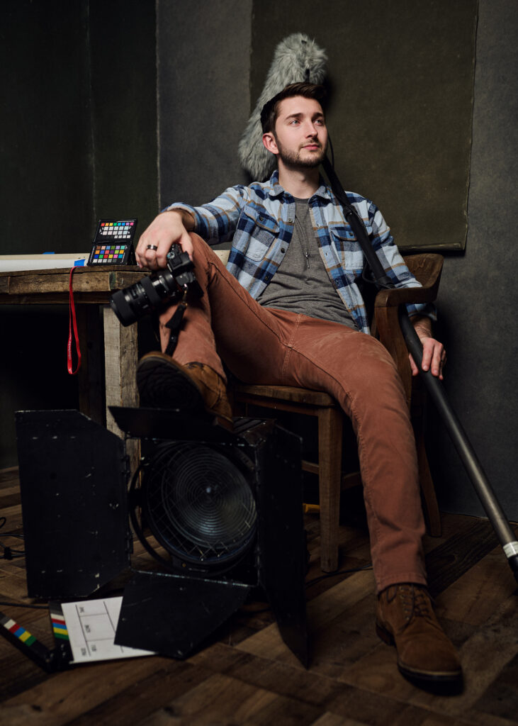 jake schumacher sitting at table surrounded by video gear